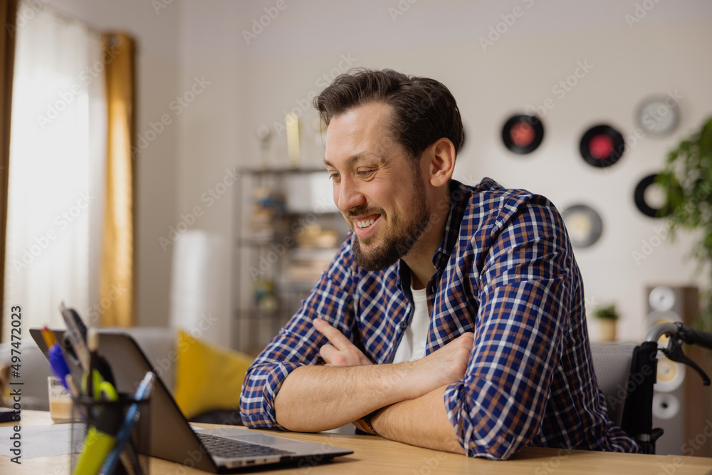 A middle-aged man in a wheelchair attends an online meeting of the company where he works. There they discuss important topics about disability. Living with Disabilities. A middle-aged man in a wheelchair attends an online meeting of the company where he works. There they discuss important topics about disability. Living with Disabilities.