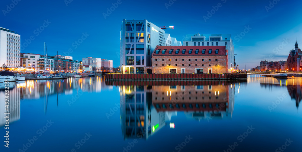 Beautiful architecture of Gdansk old town reflected in the Motlawa river at dusk, Poland