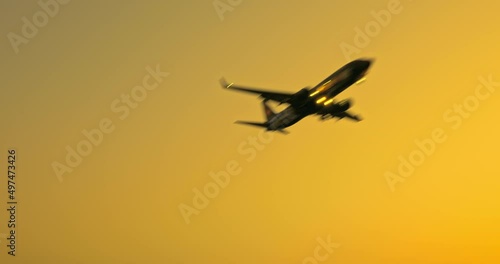 Airplane preparing to land over the airport at sunset. travel concept. 4K real time footage.