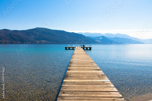 Panoramic view of Lake Attersee with wooden pier and mountain range in the background. Salzkammergut Upper Austria © familie-eisenlohr.de