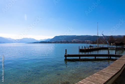 Fototapeta Naklejka Na Ścianę i Meble -  Panoramic view of Lake Attersee with wooden pier and mountain range in the background. Salzkammergut Upper Austria