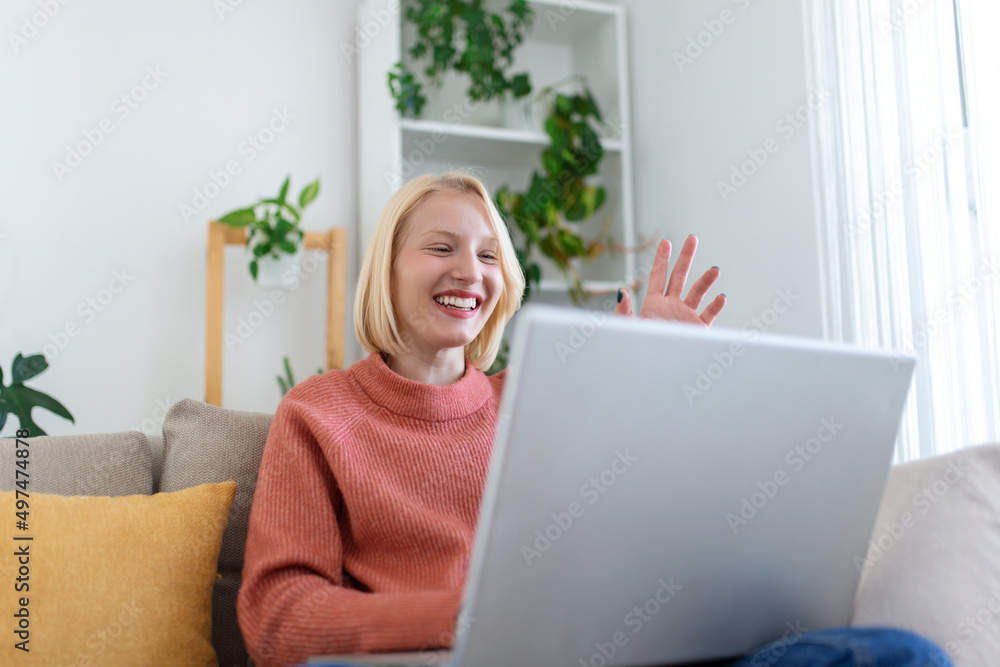 Smiling young woman using laptop at home, looking at screen, chatting, having video conference . business trainer tutoring by webcam, online training, e-coaching concept Smiling young woman using laptop at home, looking at screen, chatting, having video conference . business trainer tutoring by webcam, online training, e-coaching concept