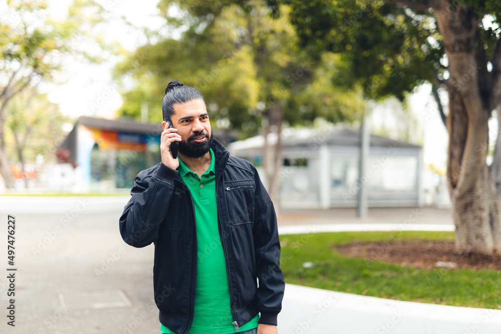 bearded man talking on mobile phone bearded man talking on mobile phone