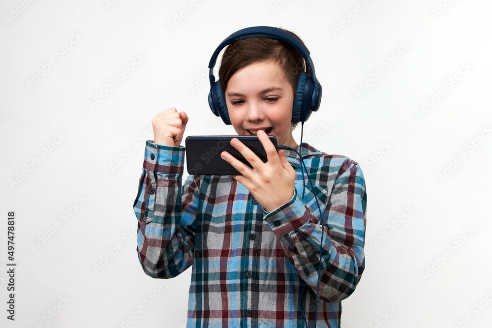 Boy using smartphone on a white background with copy space. Boy using smartphone on a white background with copy space.