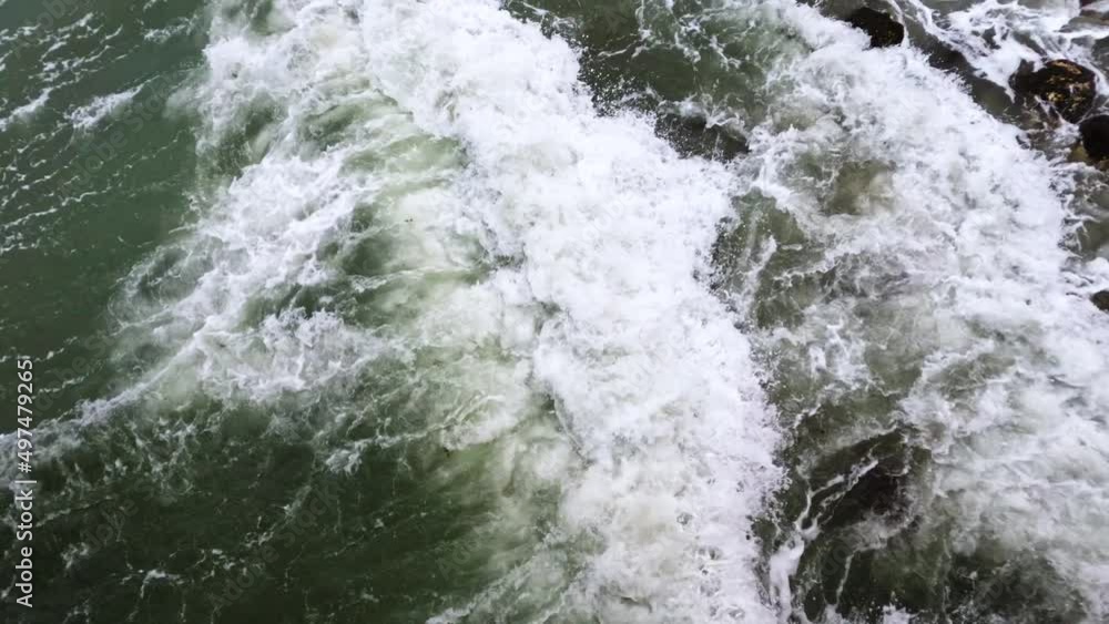 4k Static shot of waves and rocks in the ocean water. 4k Static shot of waves and rocks in the ocean water.