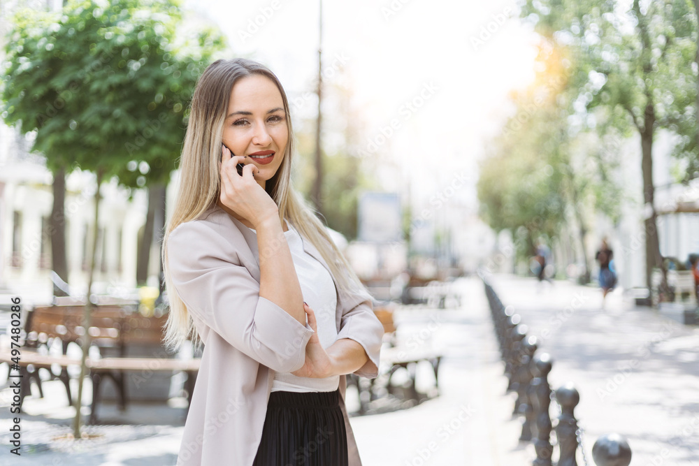 Fototapeta premium attractive young woman using a smartphone to call a taxi .