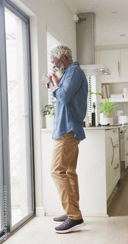 Vertical video of senior african american man talking on smartphone at home Vertical video of senior african american man talking on smartphone at home