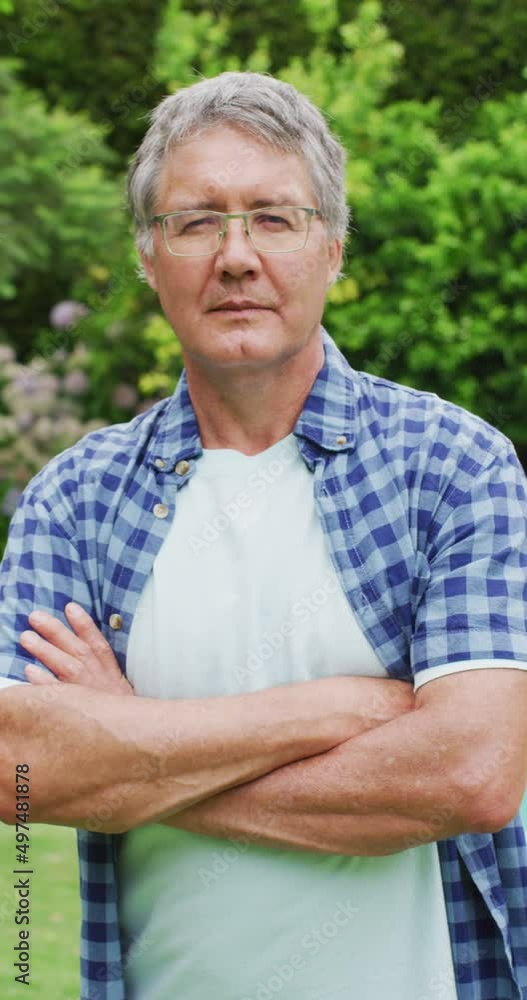 Vertical video of portrait of happy caucasian man in garden Vertical video of portrait of happy caucasian man in garden