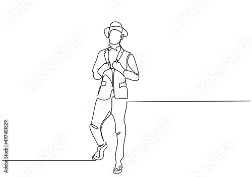 stylishly dressed gentleman businessman model male in a suit hat posing