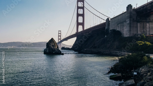 Golden Gate Bridge at twilight viewed from cliffs on north side of bridge with boat photo