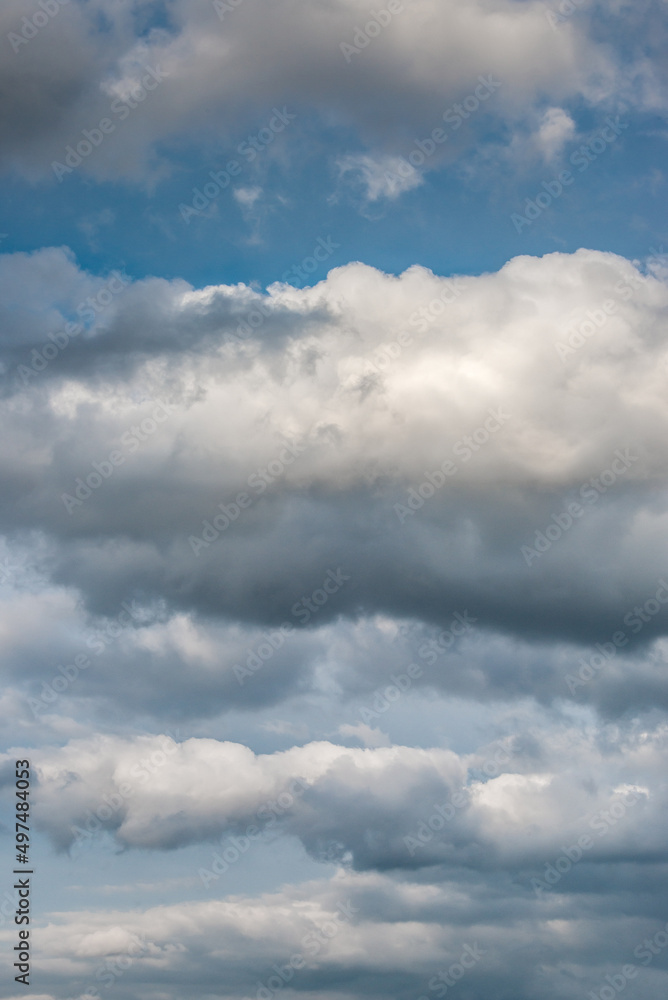 Fototapeta premium Cover page with deep blue sky with illuminated clouds as a background.