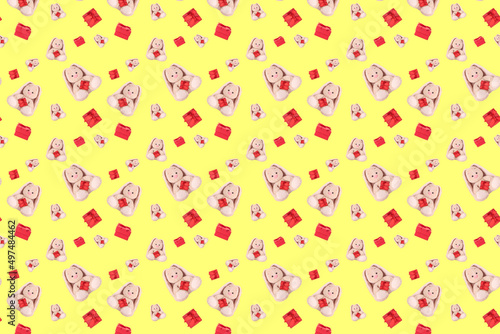 Seamless pattern with a rabbit and a red gift.