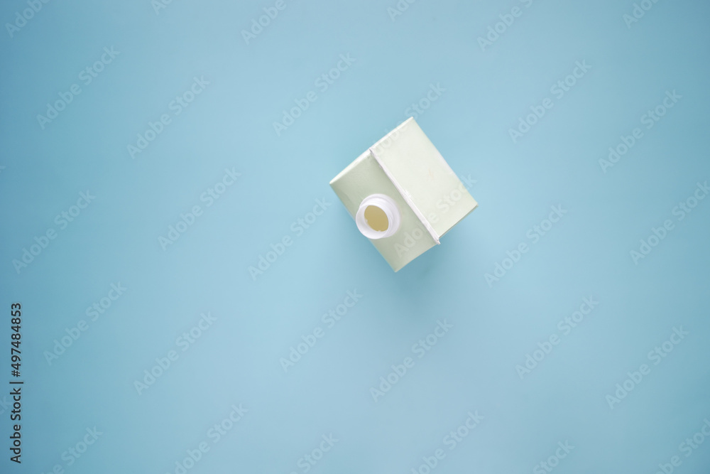 top view of a milk container on light green background top view of a milk container on light green background