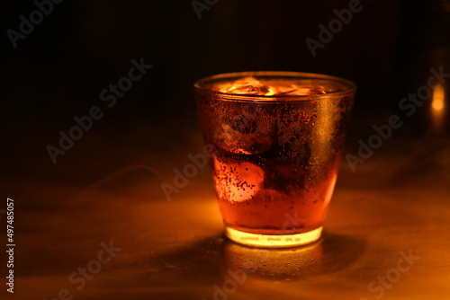 cold cola on wooden table gives a cool and refreshing feeling.