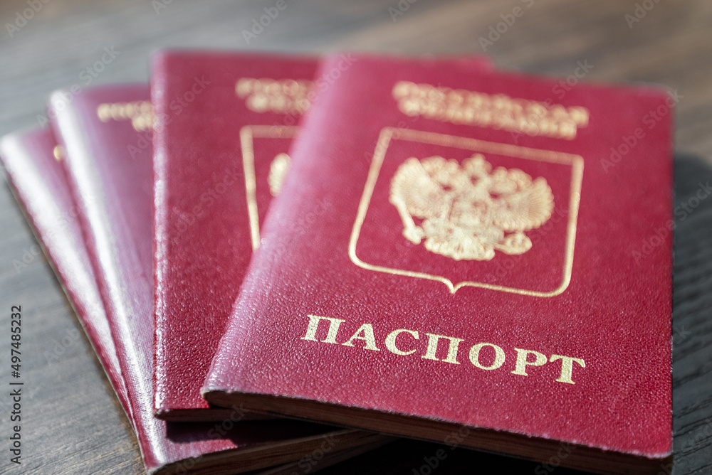 Stack of Russian passport documents on wooden table surfacee Stack of Russian passport documents on wooden table surfacee