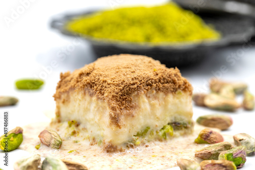 Cold baklava on a white background. Cold baklava prepared with milk and pistachio is very popular. Traditional Mediterranean cuisine delicacies. close-up cold baklava. local name soguk baklava photo