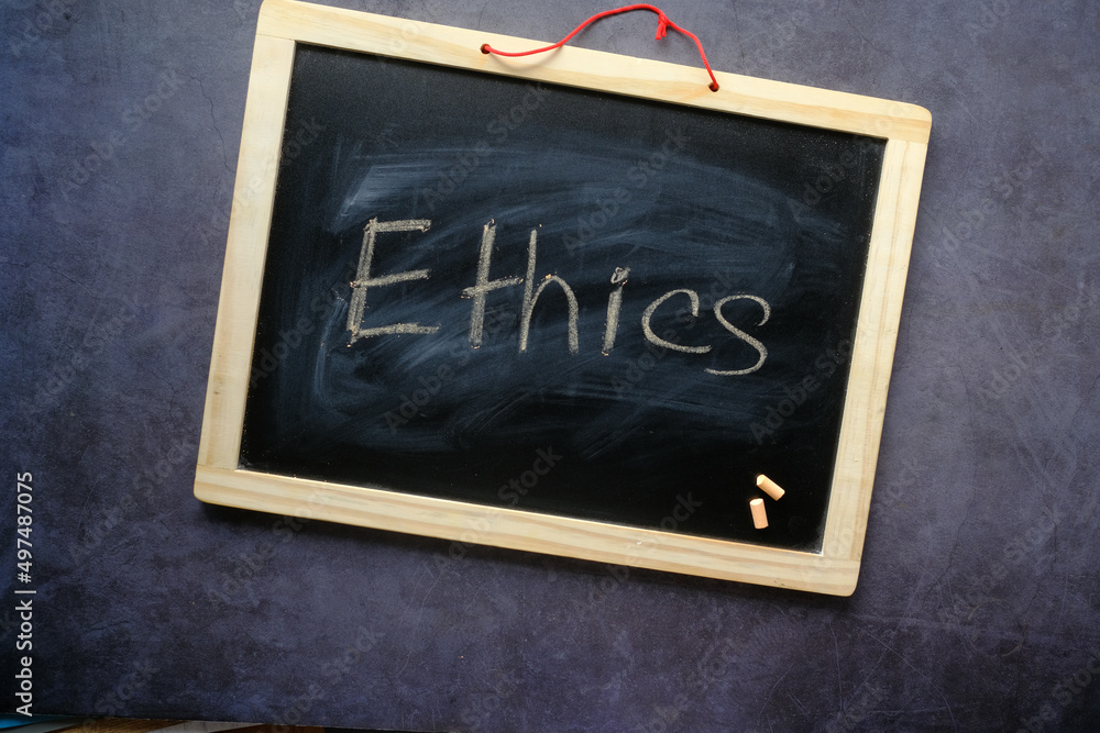Ethics word on a chalk board on black background ,