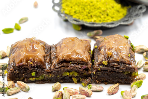 Chocolate baklava with pistachio on a white background. Traditional Mediterranean cuisine delicacies. Close-up Chocolate Baklava. local name cikolatali baklava photo