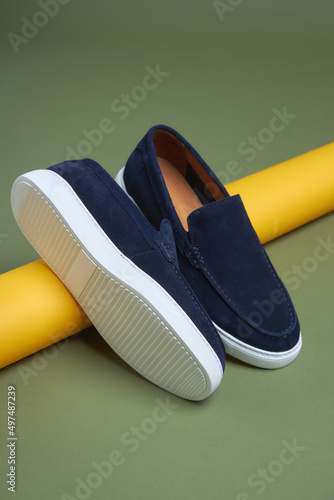 Fashion male blue shoes on green background. Fashion shoes made of eco-leather spring-summer 2022.