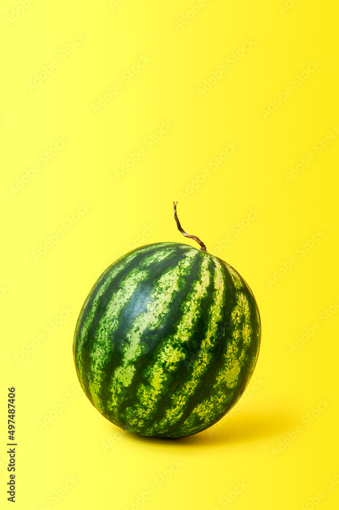 Ripe watermelon on yellow background Ripe watermelon on yellow background