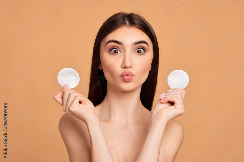 beautiful young woman holding two white cotton disks pad beautiful young woman holding two white cotton disks pad