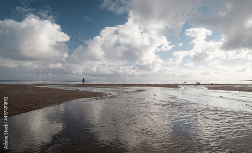 Man walking in water along a beach