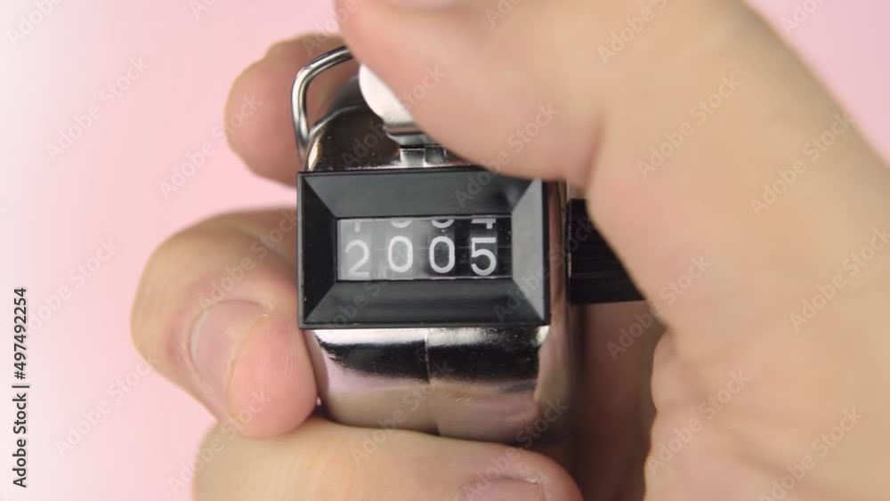 Hand counter clicker counting hand four digits analog close up 02. Hand triggering counter clicking analog clicker numbers. Years 2000-2035 Hand counter clicker counting hand four digits analog close up 02. Hand triggering counter clicking analog clicker numbers. Years 2000-2035