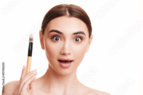 young beautiful woman with make-up brush for powder