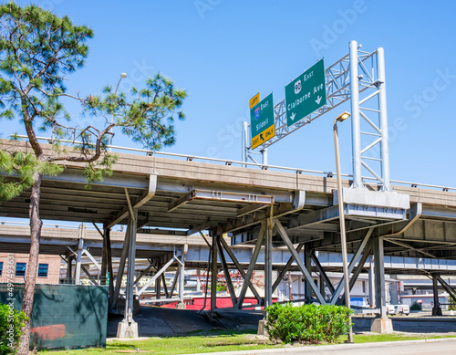 NEW ORLEANS, LA, USA - APRIL 3, 2022: Elevated highway over Claiborne Avenue with road signs for Claiborne Avenue and Slidell Exits in New Orleans, LA, USA photo