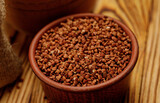 Buckwheat groats in bowls and bags on a wooden background. High quality photo