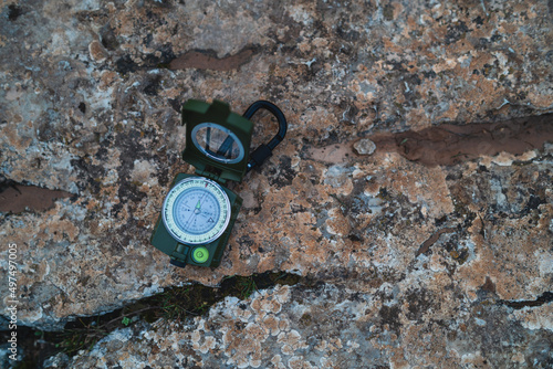 Top view of an open green tactical prismatic compass on rock, El Torcal de Antequera, Malaga, Spain
