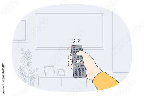 Remote control and entertainment concept. Human hand holding remote controller and switching on television hanging on wall vector illustration 