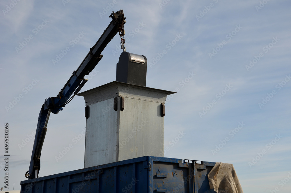 waste recycling in separated waste containers. the bottom lid opens when the crane is pulled over the body of the truck, the raw material is dumped into the sorted waste. underground metal container, 
