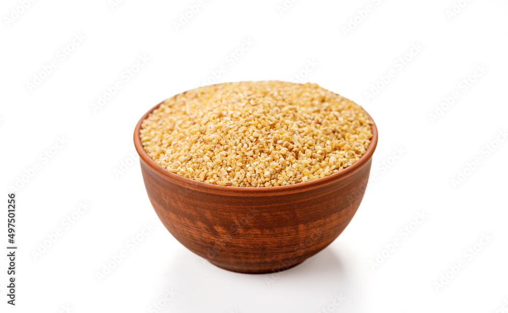 Wheat groats in bowls and bags isolated on a white background. High quality photo Wheat groats in bowls and bags isolated on a white background. High quality photo