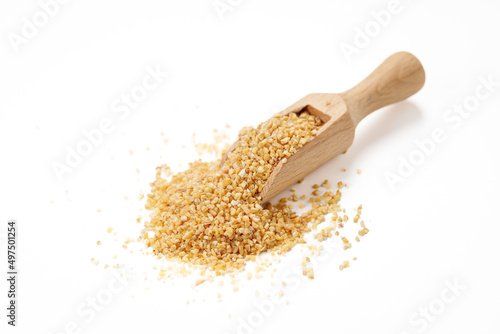 Wheat groats in bowls and bags isolated on a white background. High quality photo