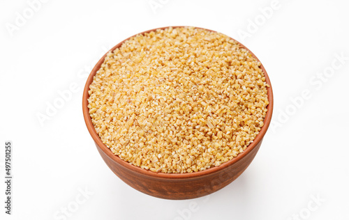 Wheat groats in bowls and bags isolated on a white background. High quality photo