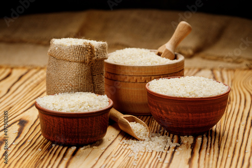 Polished round rice in bowls and bags on a wooden background. High quality photo