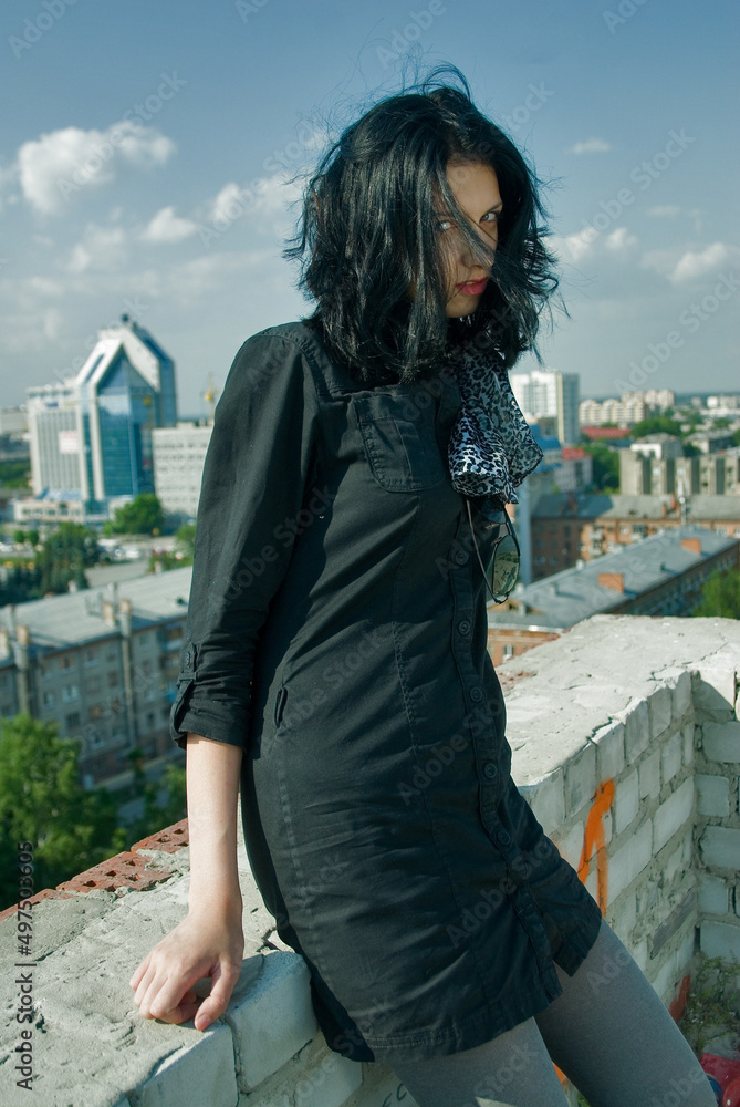 Fototapeta premium Young cool woman relaxes on roof