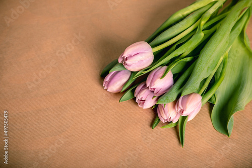 Bunch of violet tulips lying on a table.