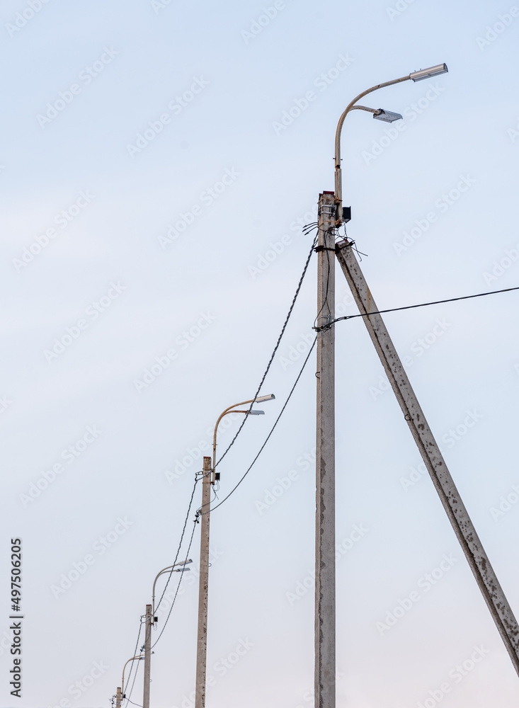Street lamp posts in perspective against the sky. Street lamp posts in perspective against the sky.