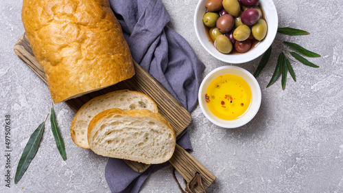 Bowl of delicious olives with oil and bread