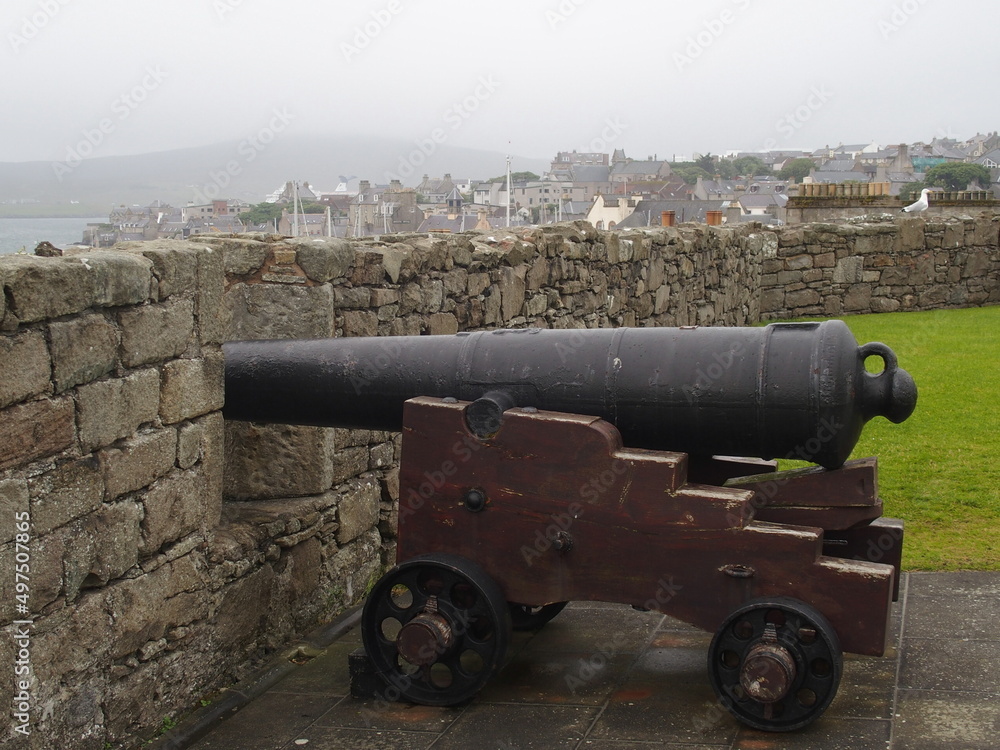 Historic cannon at Fort Charlotte, with the town of Lerwick in the background, Shetland Islands, Scotland, UK
