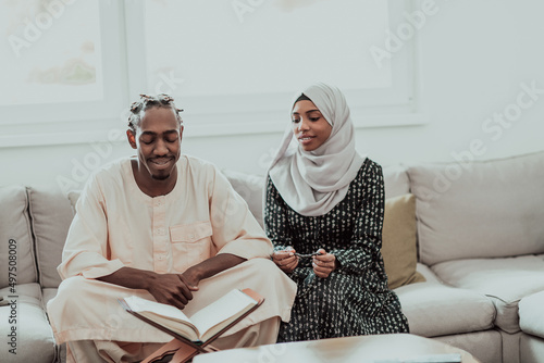 Photography African Muslim couple at home in Ramadan reading Quran holly Islam book