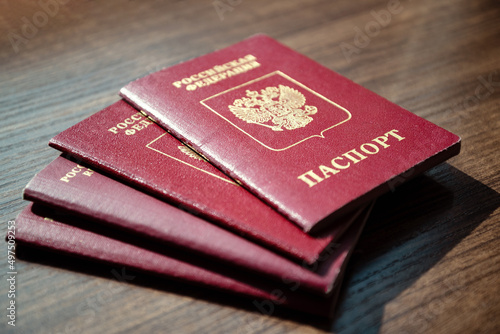 Stack of Russian passport documents on wooden table surface