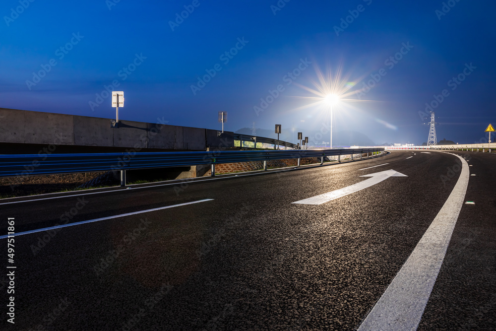 Empty asphalt highway and street lights with beautiful sky at night