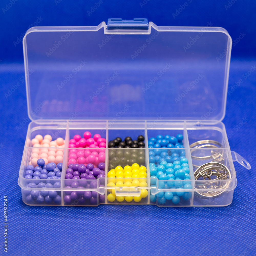 Container organizer with cells for small items for women's needlework and creativity. Container organizer with cells for small items for women's needlework and creativity.