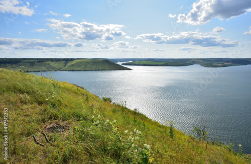 The panoramic landscape of Bakota Bay view. Dniester river  Ukraine. The banks of a large river with small waves on the water. Panoramic river  high banks  green hills. Summer day.