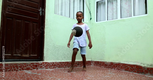 African child playing with ball  Black young boy kid plays sport by himself