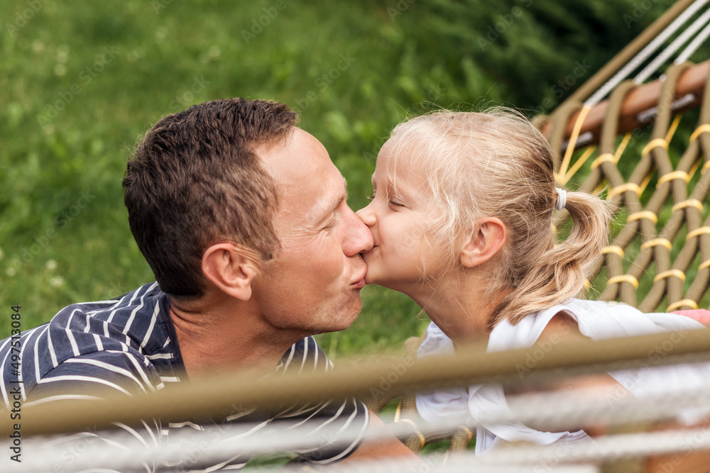 Kiss of relatives. Daughter kiss dad on nature background. Happy Family Holiday. Father's Day. Kiss of relatives. Daughter kiss dad on nature background. Happy Family Holiday. Father's Day.