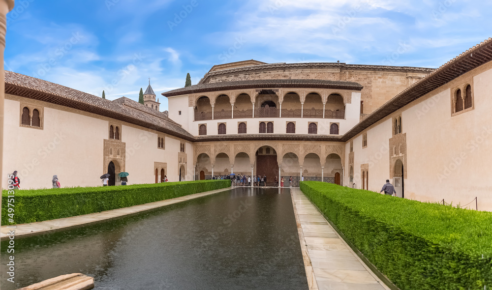 View at the Court of the Myrtles (Patio de los Arrayanes) is part of the Nasrid Palaces on fortress complex of the Alhambra citadel, tourist people visiting